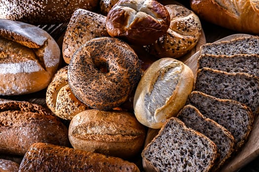 Assorted bakery products including loaves of bread and rolls.