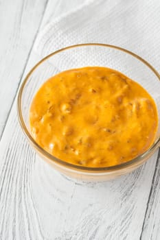 Glass bowl of burger sauce on the wooden table