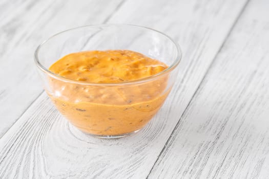 Glass bowl of burger sauce on the wooden table