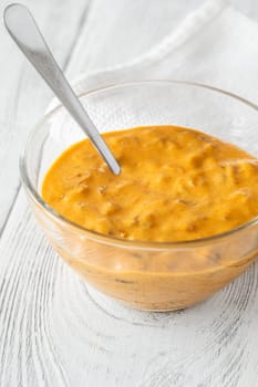 Glass bowl of burger sauce on the wooden table