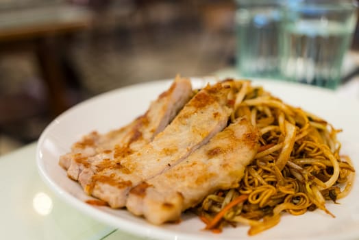Pan fried pork chop noodles on dish