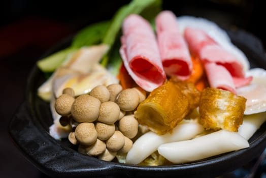 Fresh hot pot in bowl with mushroom meat and vegetable