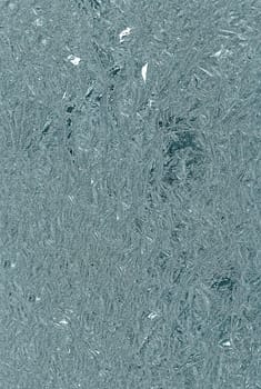 Grey glass, ice texture. Winter background, natural frosty pattern on the window