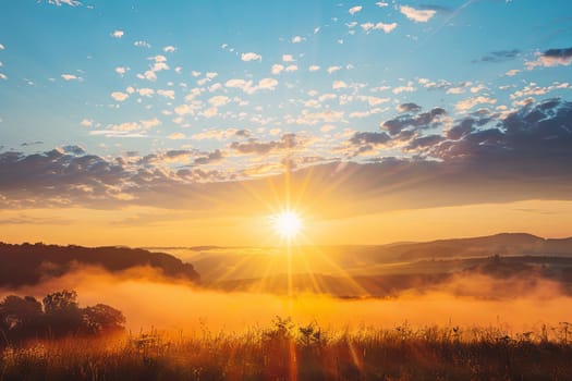 The sun is seen dipping below the horizon, casting a warm orange glow over a valley blanketed in thick fog. The mist obscures the landscape, creating a mysterious and moody atmosphere.