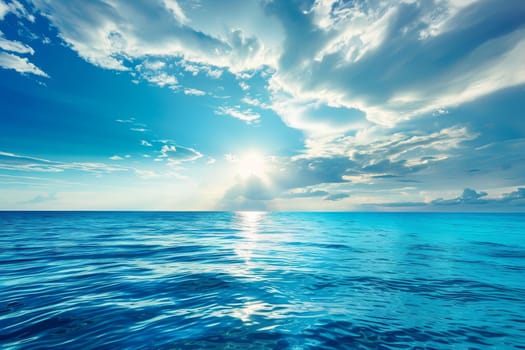 The sun breaks through the clouds casting a radiant glow over the ocean, creating a stunning display of light and shadow on the waters surface.