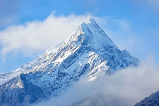A snow-covered mountain is illuminated by daylight in this scene. The mountain stands prominently under a clear sky, with the snow glistening in the sun.