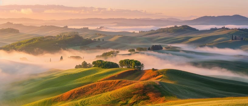 Undulating hills shrouded in mist under a pastel dawn sky create a tranquil and dreamy landscape