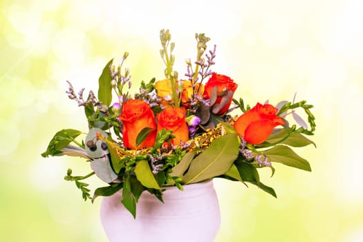 Closeup of a beautiful bouquet of bright red yellow roses in a vase over abstract yellow spring background texture for Valentine's Day, wedding or other holidays.