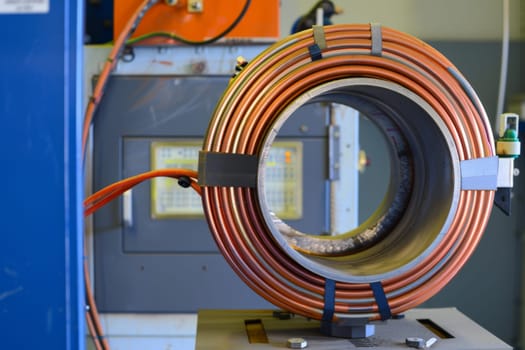 A detailed view of a hose attached to a machine, showing the connection points and the material of the hose. The machine appears to be in use, with the hose actively involved in the operation.