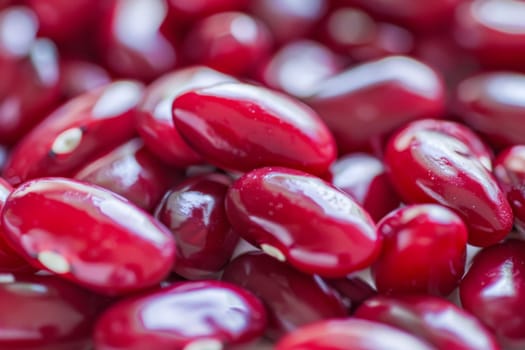 A group of red beans neatly stacked next to each other, creating a vibrant and colorful display. The beans are uniform in size and shape, showcasing their rich red hue.