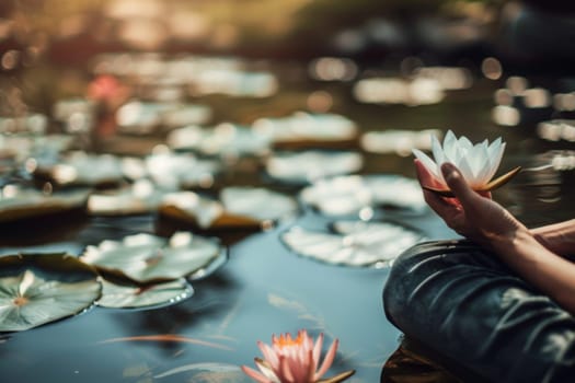 A person is holding a flower in their hand. The individuals fingers gently grasp the delicate petals of the flower. The background is blurred, drawing focus to the interaction between the person and the flower.