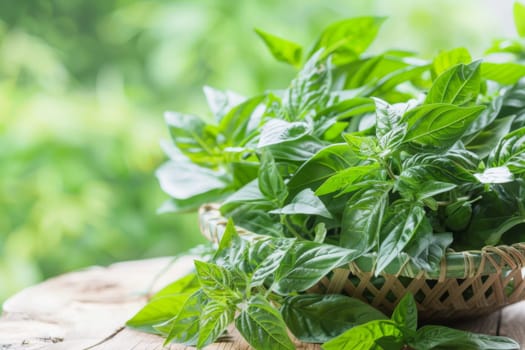A basket filled with vibrant green leaves sits atop a sturdy wooden table. The leaves are neatly arranged, creating a visually appealing display in a rustic setting.