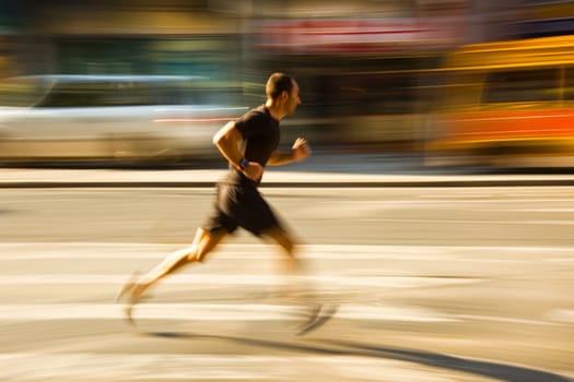 A man in motion, running down a street with a blurry background of buildings and vehicles. He is mid-stride, determined and focused on his path ahead.