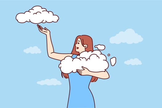 Woman takes clouds from sky, enjoying clear weather and fresh air available thanks to clean environment. Young girl seeing wonderful dream about opportunity to hold clouds with firmament in hands