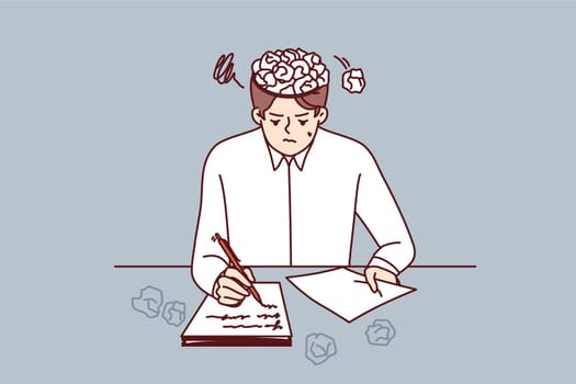 Man writer writes story for own book, sits at table with crumpled papers instead of brain