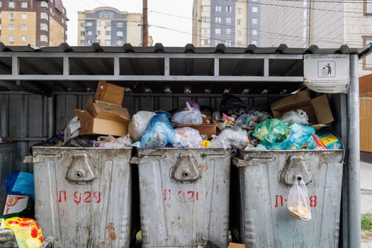 overfilled public trash bins at summer day in Bishkek, Kyrgyzstan - May 24, 2023