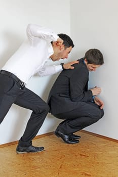 Argument between two men. An aggressive man wants to hit another man