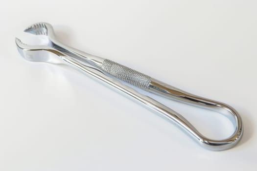 This close-up shot showcases a toothbrush lying on a clean white surface. The bristles and handle of the toothbrush are prominently featured, highlighting its design and functionality.