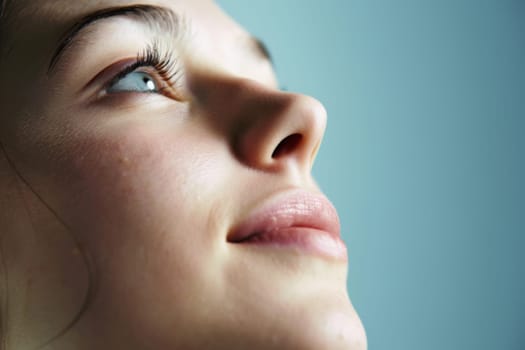 In the close-up shot, a womans face is centered, with her eyes closed. Her features are relaxed, and she appears to be in a state of calmness.