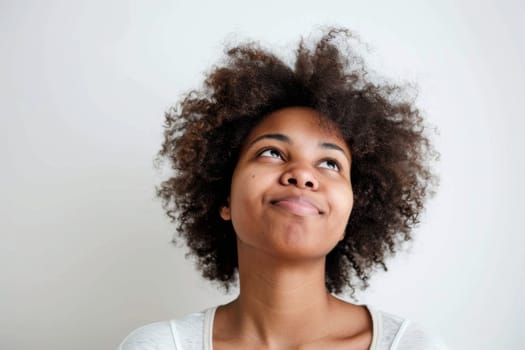 A detailed view of an individual with a voluminous afro hairstyle, showcasing the texture and structure of the hair up close. The focus is on the curls, strands, and overall shape of the afro.