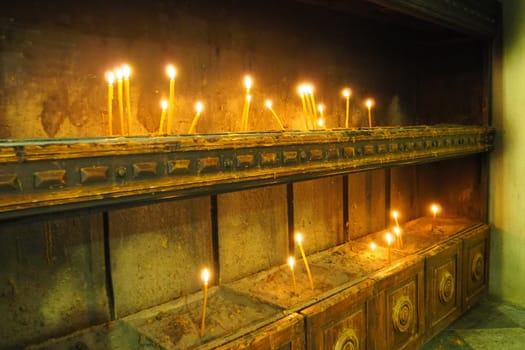 Kotor Montenegro 08.11.22 The Church of St. Nicholas attracts Orthodox pilgrims. Interior decoration of church. A metal structure with sand and water for placing lighted candles for health and peace
