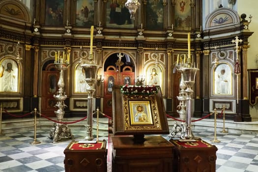 Kotor Montenegro 08.11.22 The Church of St. Nicholas attracts pilgrims tourists. Orthodox center. Interior and decoration of church, altar, icons, candles, chandeliers and antique tiles on the floor