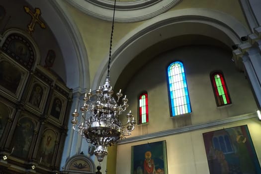 Kotor Montenegro 08.11.22 The Church of St. Nicholas attracts pilgrims tourists. Orthodox center. Interior and decoration of church, altar, icons, candles, chandeliers and antique tiles on the floor