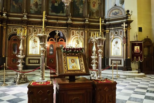 Kotor Montenegro 08.11.22 The Church of St. Nicholas attracts pilgrims tourists. Orthodox center. Interior and decoration of church, altar, icons, candles, chandeliers and antique tiles on the floor