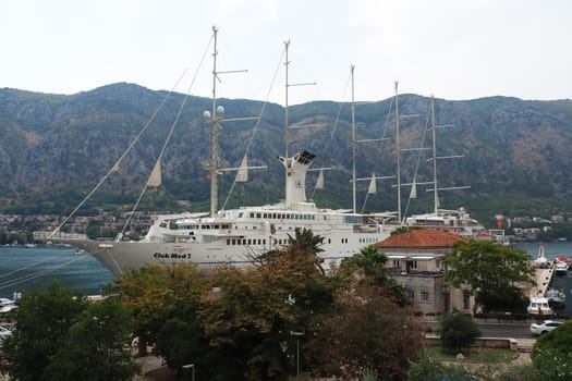 Kotor, Montenegro, 08.11.22 view of Adriatic Sea from historical center of old town. Cruise ship, tourists, cars and mountains in summer evening. Tourism business in the Balkans and the Mediterranean