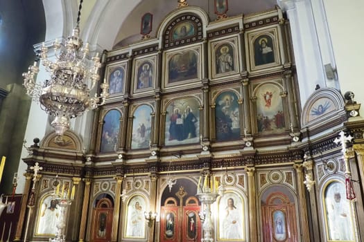 Kotor Montenegro 08.11.22 The Church of St. Nicholas attracts pilgrims tourists. Orthodox center. Interior and decoration of church, altar, icons, candles, chandeliers and antique tiles on the floor