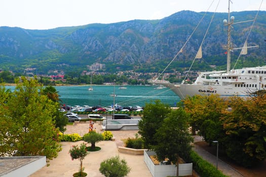 Kotor, Montenegro, 08.11.22 view of Adriatic Sea from historical center of old town. Cruise ship, tourists, cars and mountains in summer evening. Tourism business in the Balkans and the Mediterranean