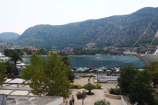 Kotor, Montenegro, 08.11.22 view of Adriatic Sea from historical center of old town. Cruise ship, tourists, cars and mountains in summer evening. Tourism business in the Balkans and the Mediterranean