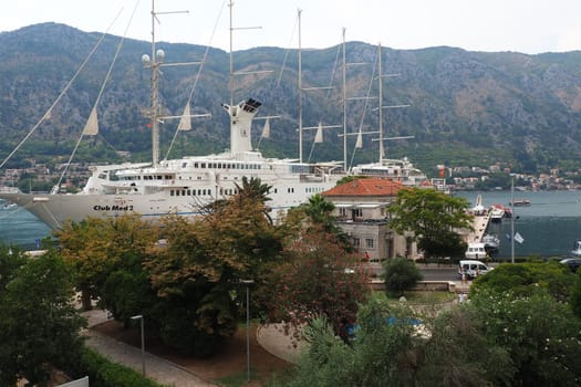 Kotor, Montenegro, 08.11.22 view of Adriatic Sea from historical center of old town. Cruise ship, tourists, cars and mountains in summer evening. Tourism business in the Balkans and the Mediterranean