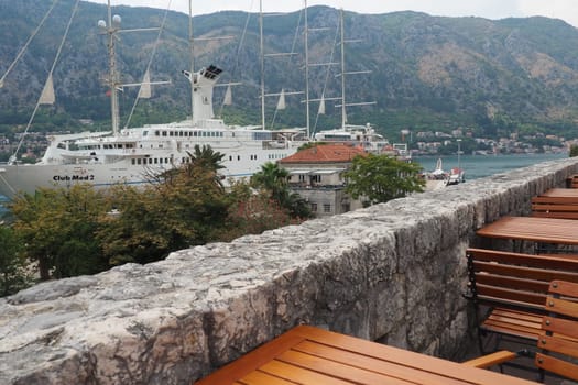 Kotor, Montenegro, 08.11.22 view of Adriatic Sea from historical center of old town. Cruise ship, tourists, cars and mountains in summer evening. Tourism business in the Balkans and the Mediterranean