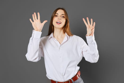 Inspired young woman shows nine fingers. Counting with fingers concept.