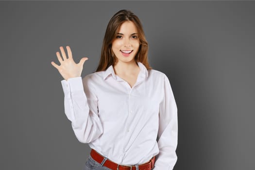 Happy woman shows five fingers. Counting with fingers concept.
