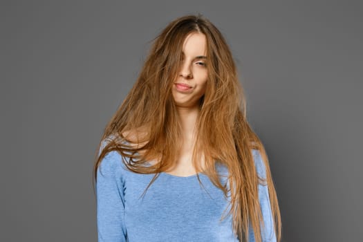 Portrait of annoyed woman with long tangled hair