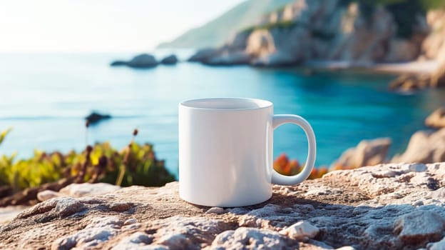 White coffee cup on a cliff overlooking the ocean