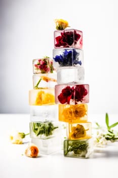 Stack of ice cubes with flowers inside and herbs, AI