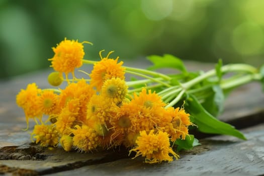 A cluster of vibrant yellow flowers arranged neatly on a sturdy wooden table. The flowers brighten the space with their cheerful hue, contrasting against the woods earthy tones.