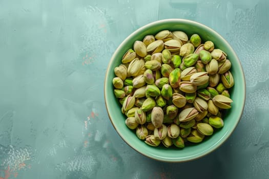 A vibrant green bowl filled to the brim with delicious pistachios resting on top of a wooden table.