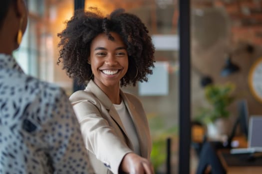 Two women confidently shaking hands in agreement, building a partnership based on trust and respect.