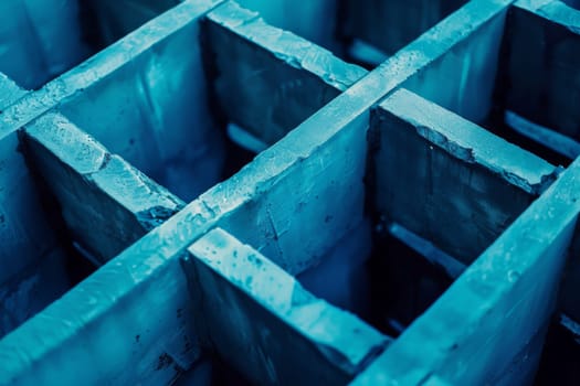 This image shows a close-up view of a bunch of concrete blocks, with each block displaying its rough texture and angular edges. The blocks are stacked closely together, creating a uniform pattern in the frame.