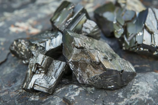 A pile of rocks of various shapes and sizes, sitting on the ground in a loose formation. The rocks appear weathered and blend naturally into the surrounding landscape.