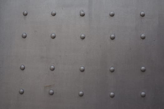 Fortress metal door with rivets. Old medieval castle in Kotor, Montenegro. Entrance to the fortress. Wrought iron door with pattern. Medieval style with rivets of steel. Beautiful stylish gothic door