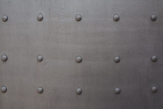 Fortress metal door with rivets. Old medieval castle in Kotor, Montenegro. Entrance to the fortress. Wrought iron door with pattern. Medieval style with rivets of steel. Beautiful stylish gothic door.
