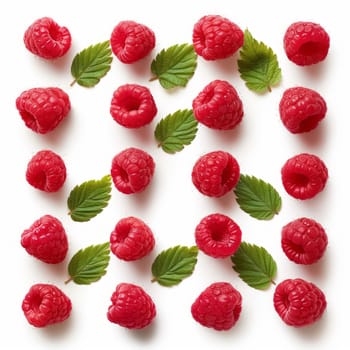 Close-up of fresh, juicy raspberries lying along with mint leaves on a white background