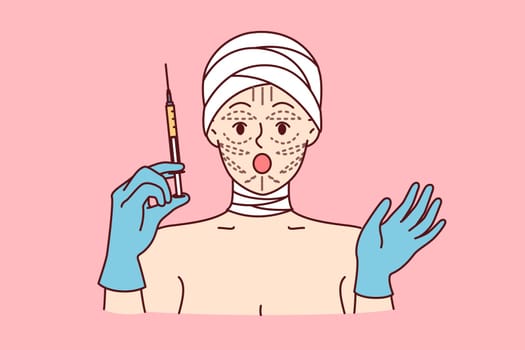 Woman is preparing for facelift procedure, and opens mouth, shocked by prices for plastic surgery, holds syringe in hands. Girl patient at plastic surgery clinic with bandaged head and lines on face