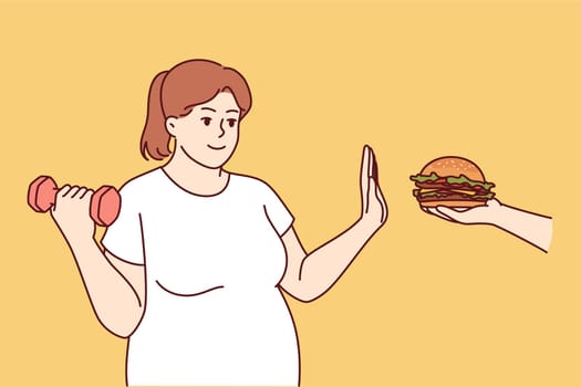 Bigsize woman goes on diet, trying to get rid of excess weight, giving up burger and lifting dumbbell. Girl decided to lead healthy lifestyle, playing sports and following low-calorie diet