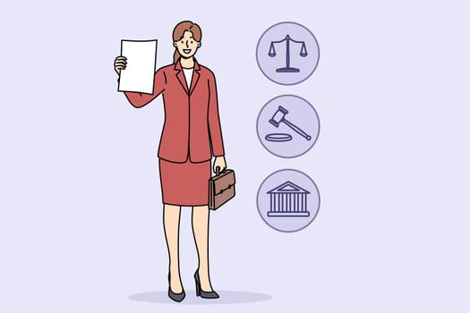 Woman lawyer demonstrates court decision on absence of claims against client, standing near legal symbols. Girl corporate lawyer with smile shows contract or permission received from ministry justice